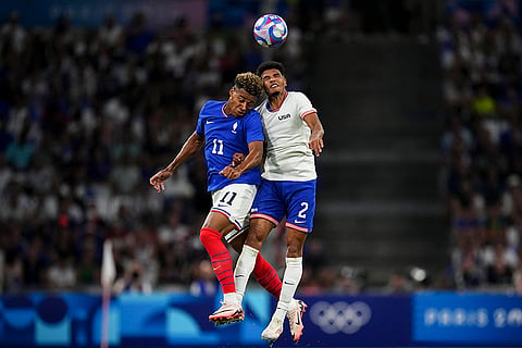 Desire Doue and Nathan Harriel battle for a head ball